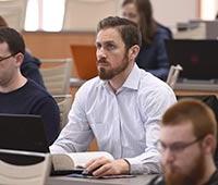 An Akron Law student in an academic class